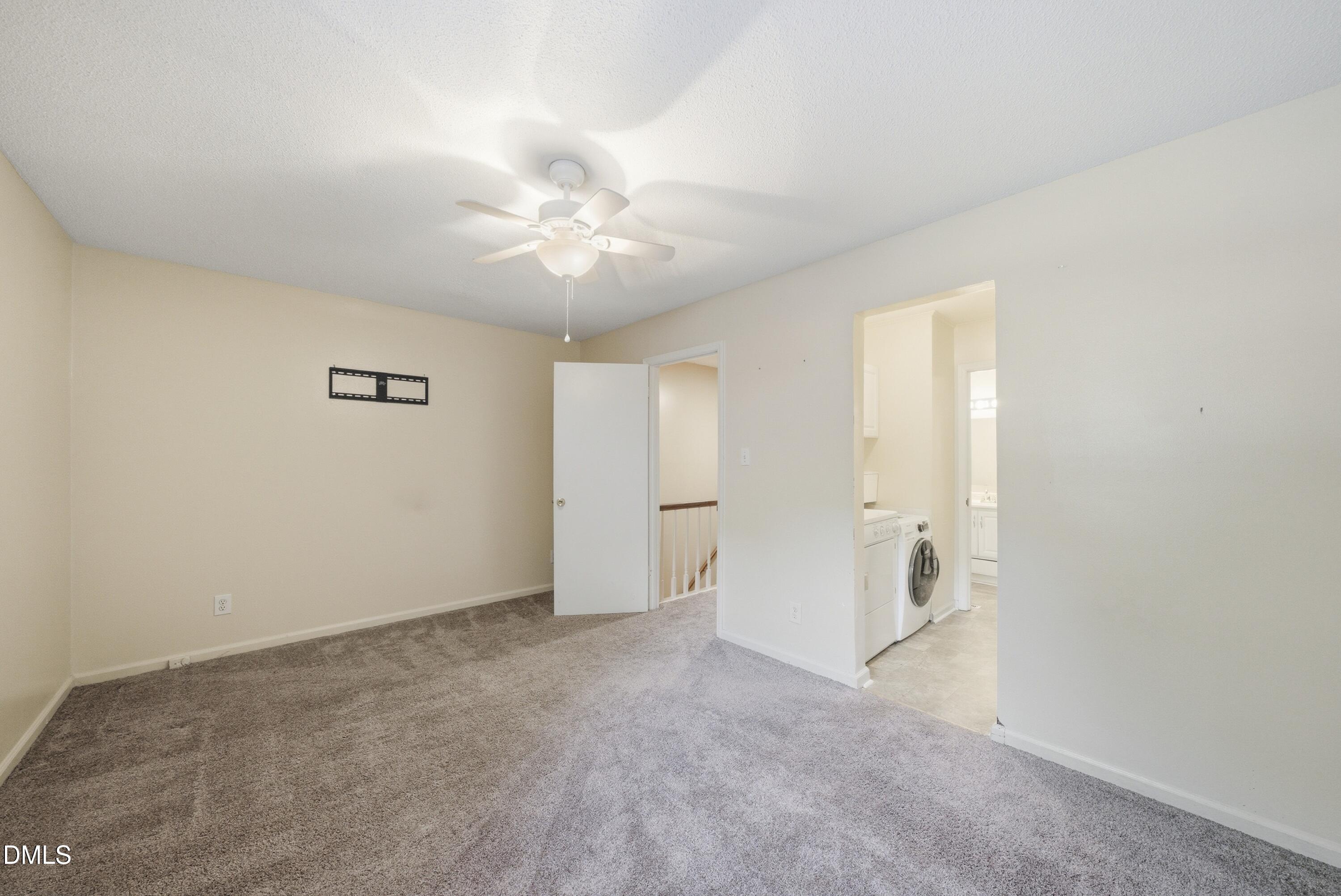 6355 New Market Way Raleigh, NC 27615 - Photo 28 of 30 an empty room with a ceiling fan and a window