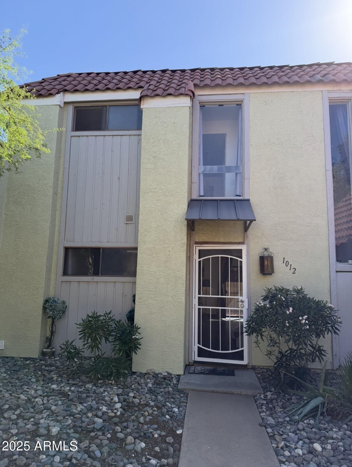 a front view of a house with garden