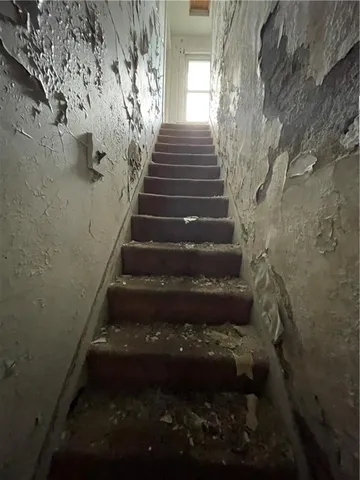 a view of staircase with white walls
