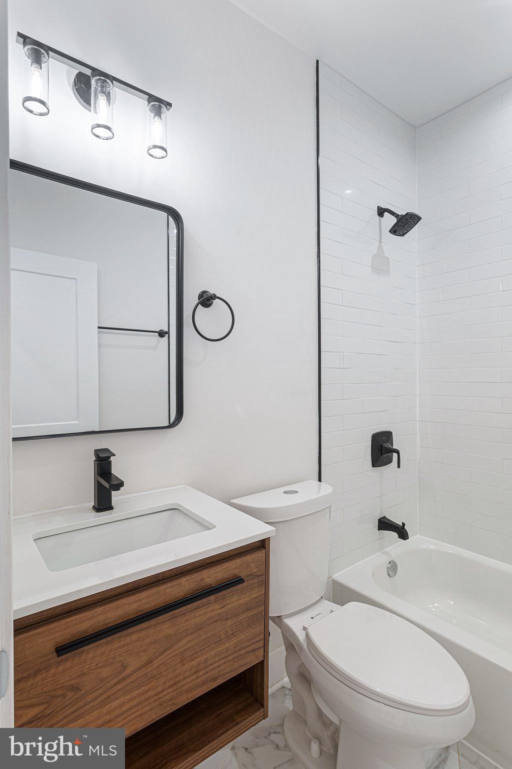 1107 Queen Street Northeast, Unit PH4 Washington, DC 20002 - Photo 14 of 28 a bathroom with a sink a toilet and shower