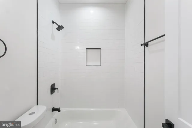 a bathroom with a bathtub with shower
