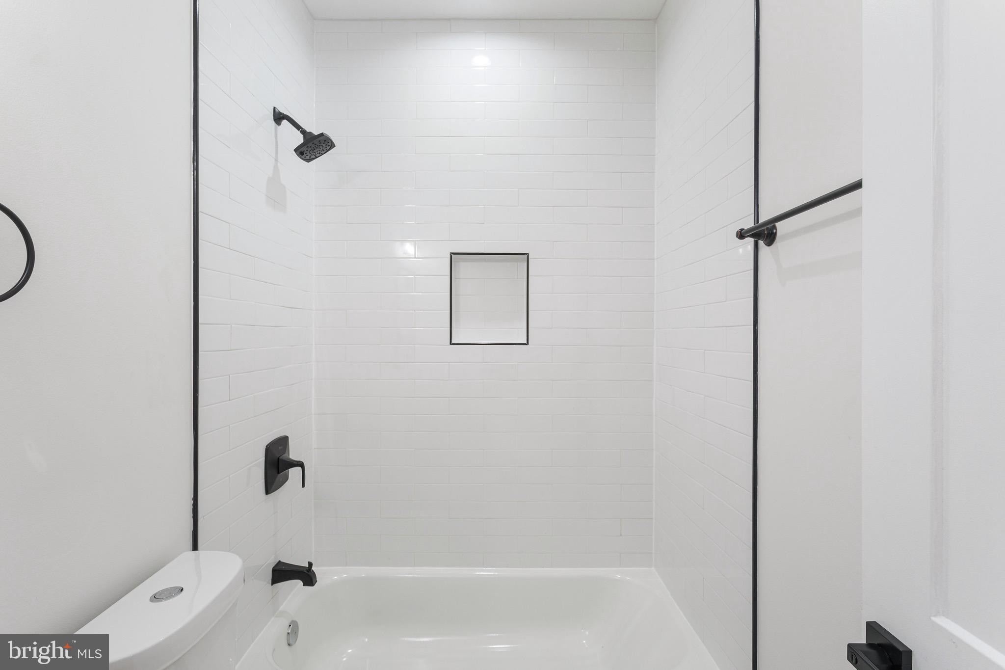 1107 Queen Street Northeast, Unit PH4 Washington, DC 20002 - Photo 15 of 28 a bathroom with a bathtub with shower