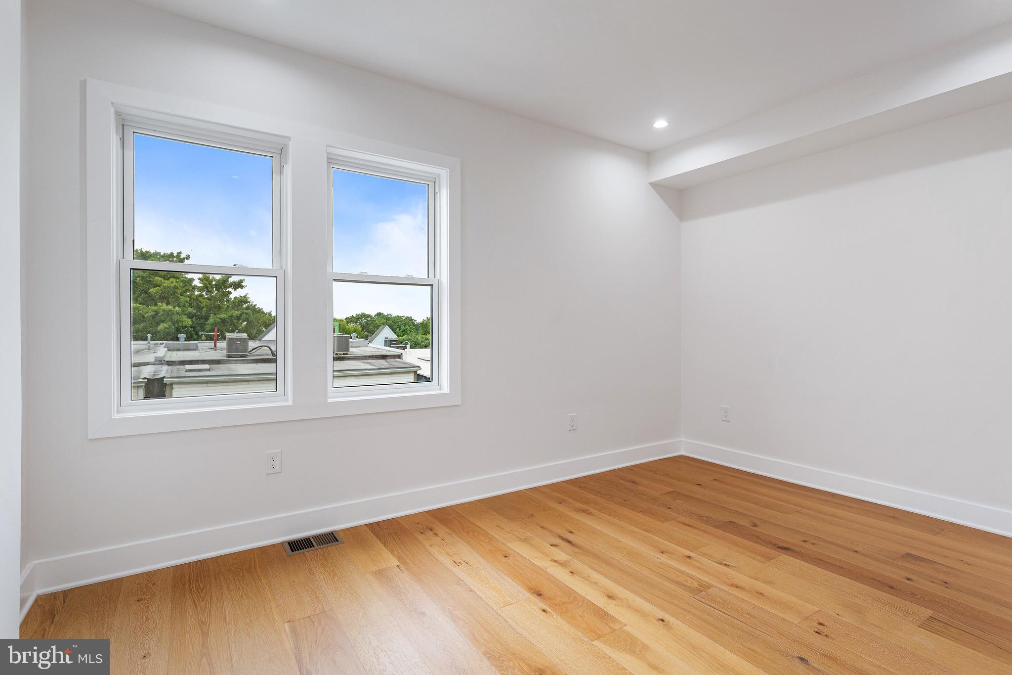 1107 Queen Street Northeast, Unit PH4 Washington, DC 20002 - Photo 17 of 28 a view of empty room with wooden floor and fan