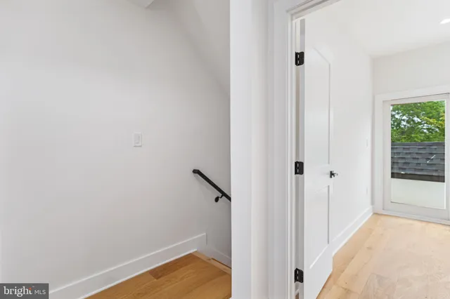 a view of a room with wooden floor and entryway