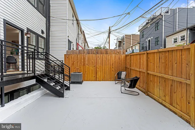 a backyard of a house with table and chairs