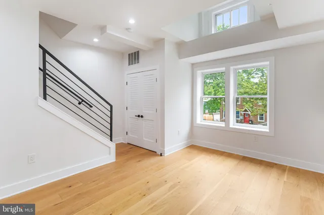 a view of an entryway with wooden floor and windows