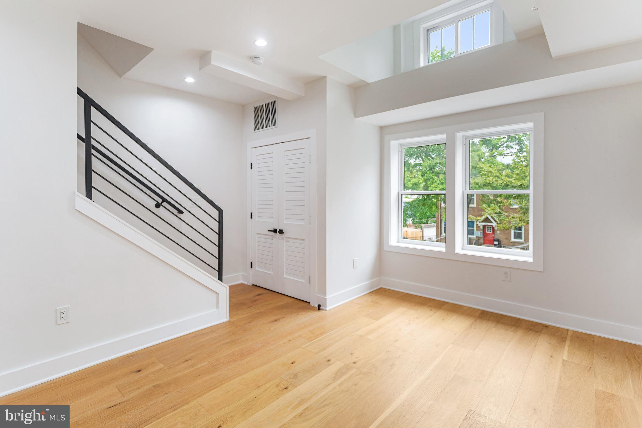 1107 Queen Street Northeast, Unit PH4 Washington, DC 20002 - Photo 6 of 28 a view of an entryway with wooden floor and windows