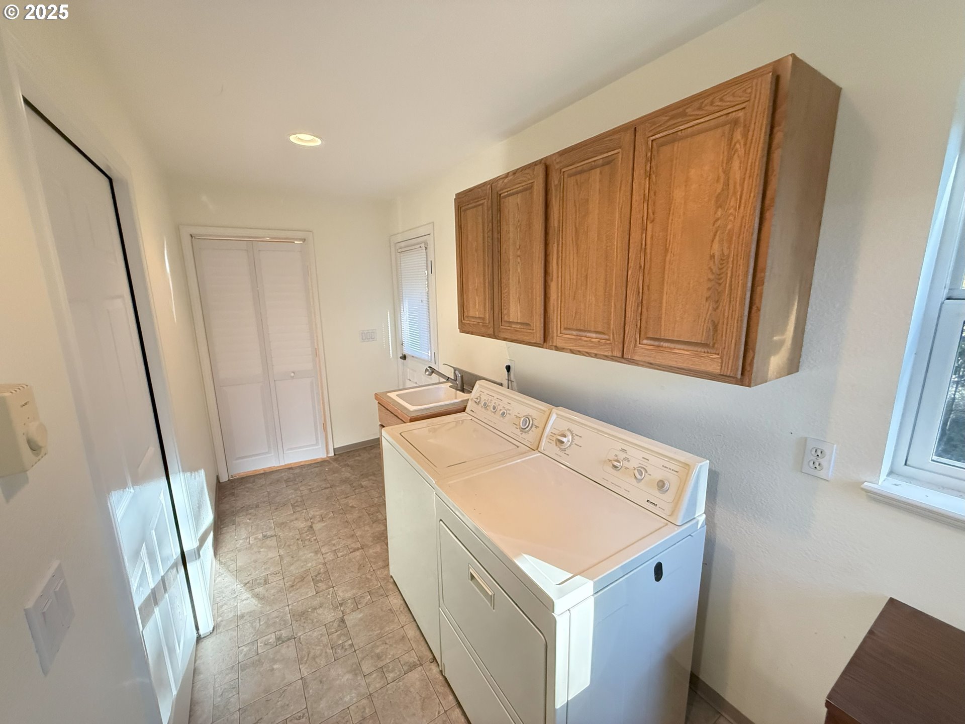 5938 View Loop Florence, OR 97439 - Photo 17 of 42 a utility room with a sink a washer and dryer