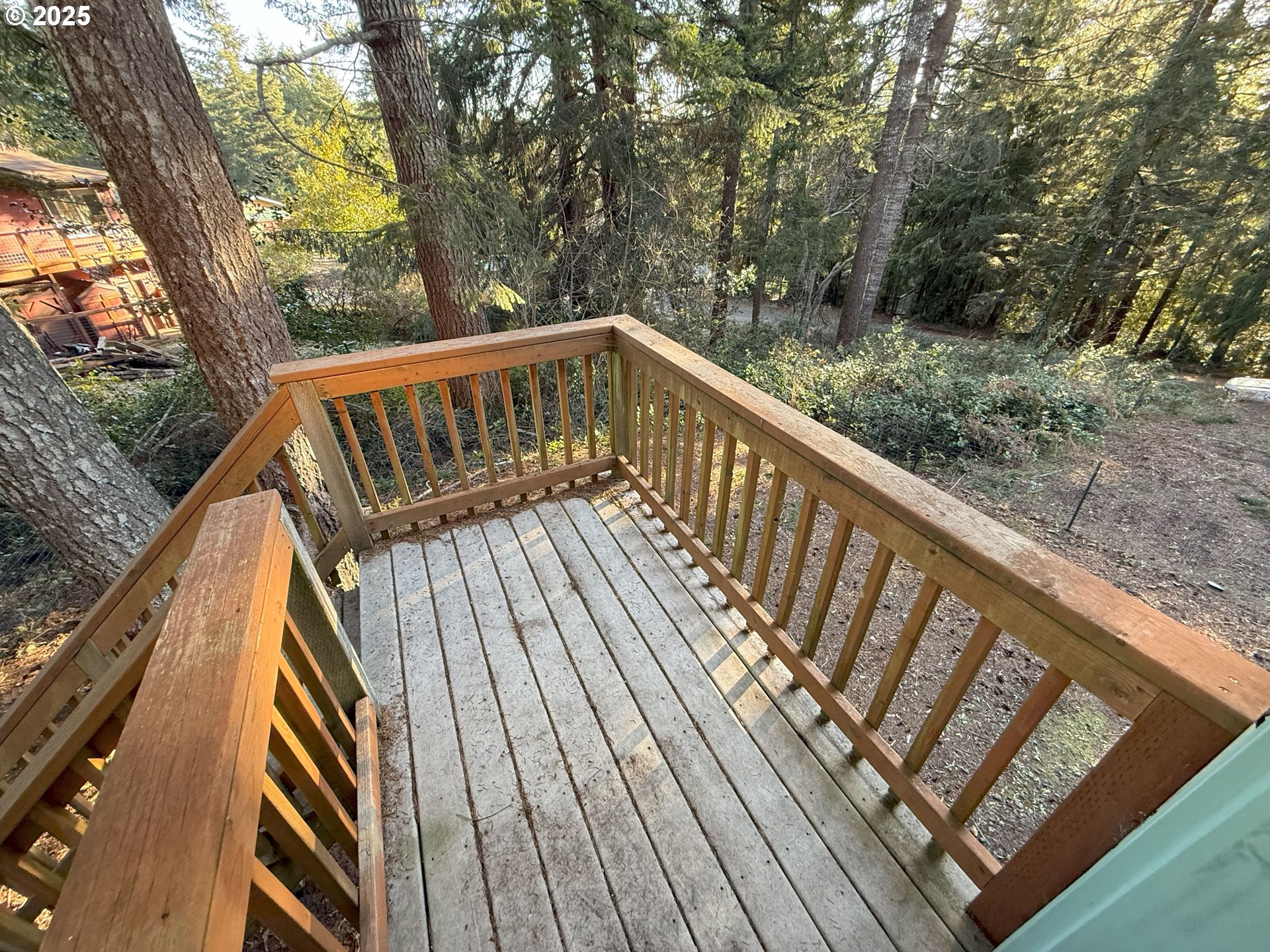 5938 View Loop Florence, OR 97439 - Photo 28 of 42 a view of balcony with wooden floor and fence