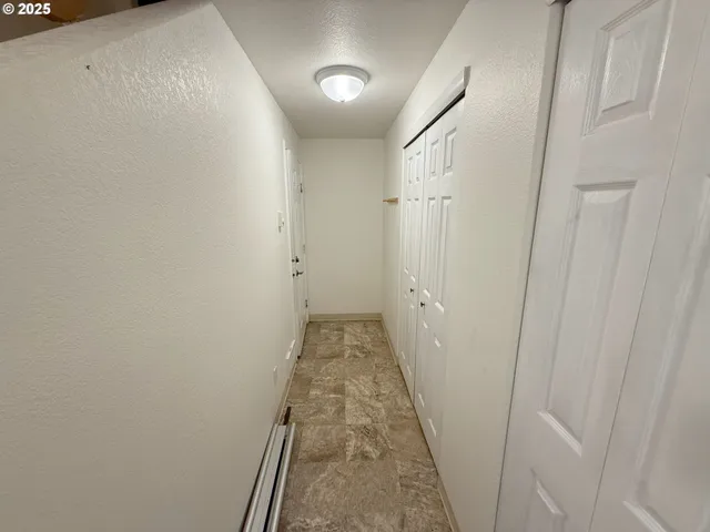 a view of closet with wooden floor