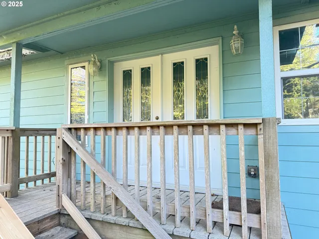 a view of an entrance with wooden floor and windows
