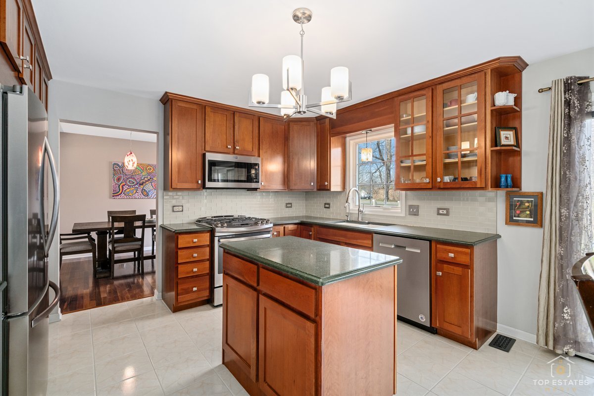 1506 Division Street St. Charles, IL 60174 - Photo 11 of 32 a kitchen with stainless steel appliances granite countertop a stove sink microwave and refrigerator