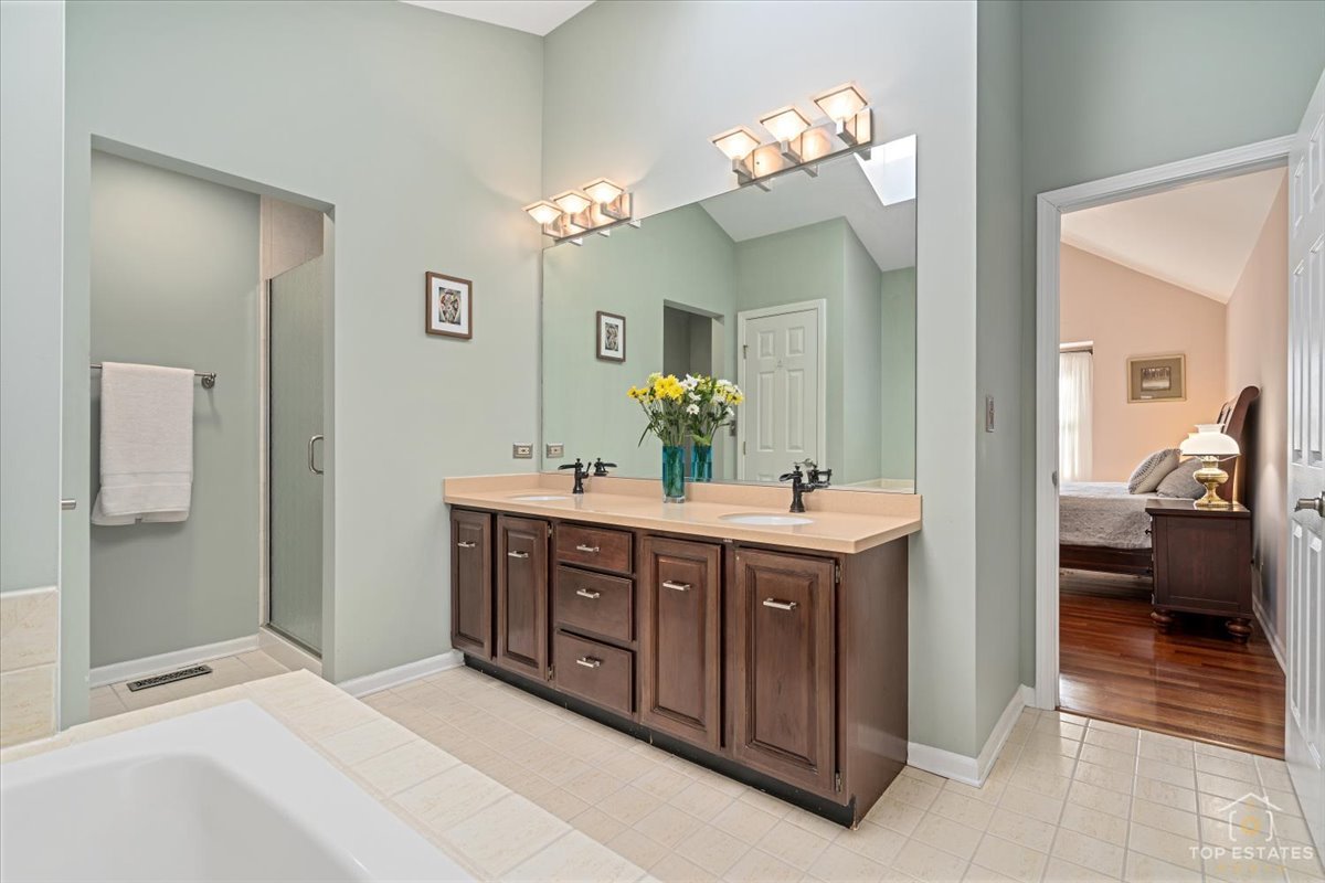 1506 Division Street St. Charles, IL 60174 - Photo 24 of 32 a spacious bathroom with a double vanity sink and a mirror