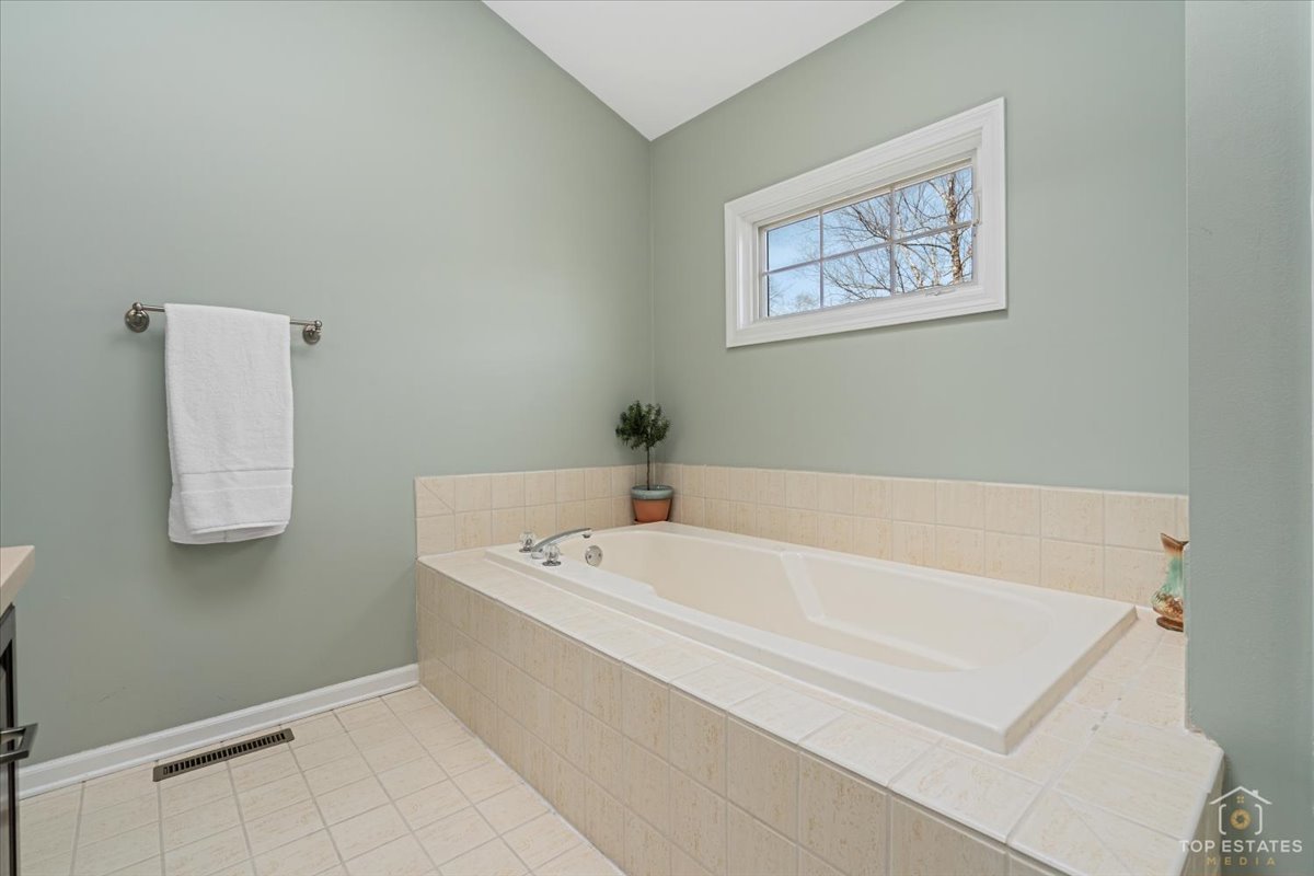 1506 Division Street St. Charles, IL 60174 - Photo 25 of 32 a bath tub sitting next to a white toilet