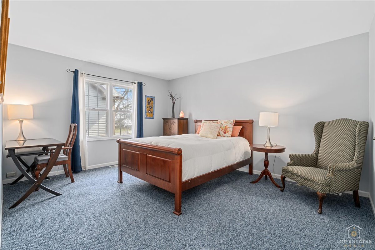 1506 Division Street St. Charles, IL 60174 - Photo 27 of 32 a bedroom with a bed chair and lamp