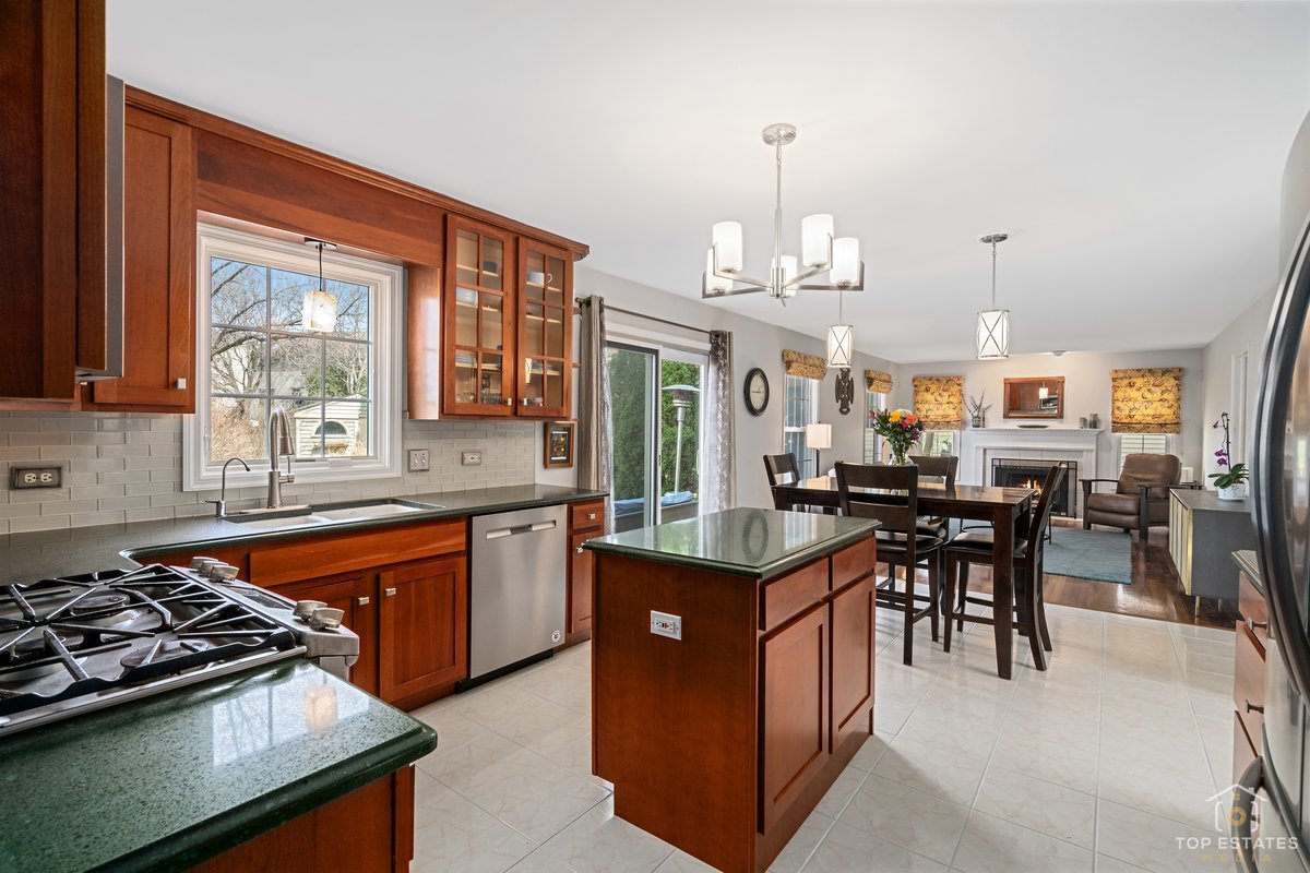 1506 Division Street St. Charles, IL 60174 - Photo 8 of 32 a kitchen with stainless steel appliances granite countertop wooden cabinets a stove and a sink