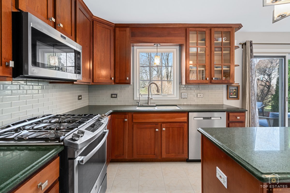 1506 Division Street St. Charles, IL 60174 - Photo 9 of 32 a kitchen with stainless steel appliances granite countertop a stove a sink and a microwave