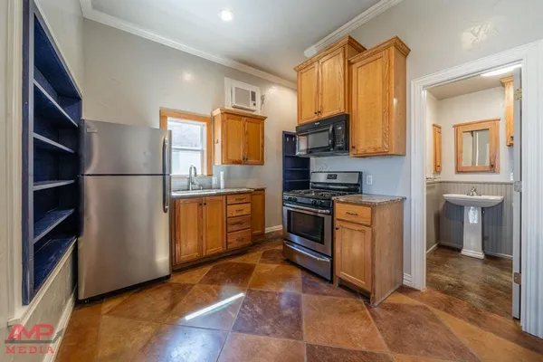 a kitchen with stainless steel appliances a refrigerator and a stove top oven