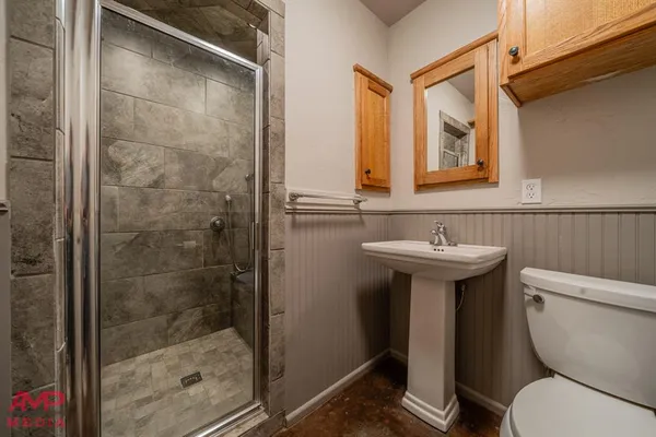 a bathroom with a sink toilet and shower