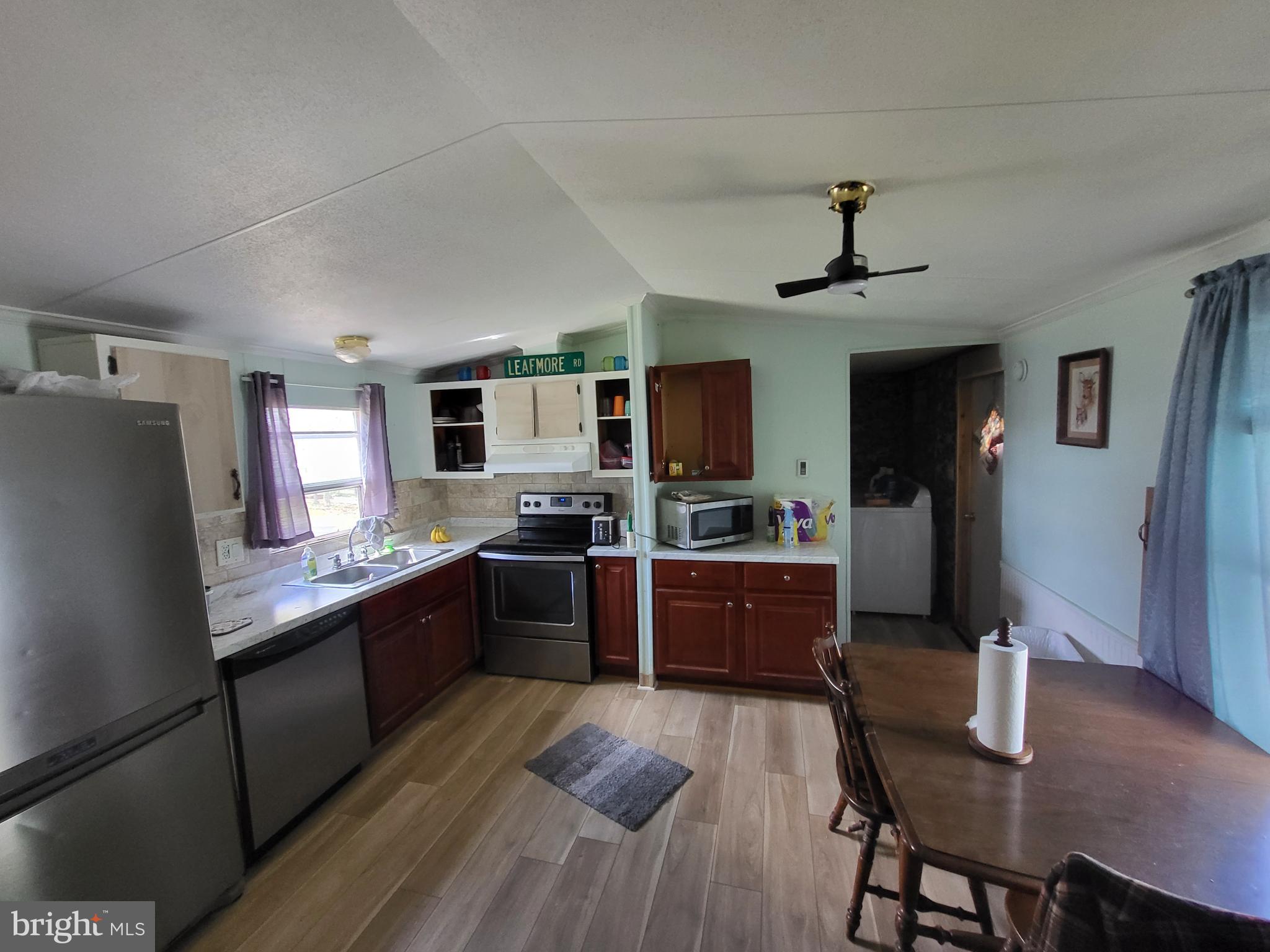 1859 Leafmore Road Chambersburg, PA 17202 - Photo 20 of 24 a large kitchen with a table chairs refrigerator and wooden floor