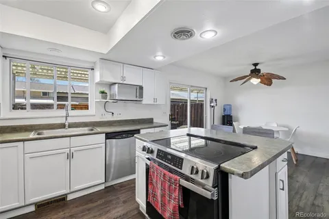 a kitchen that has a sink and a stove top oven