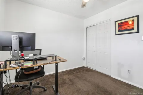 a view of a workspace with furniture and a mirror