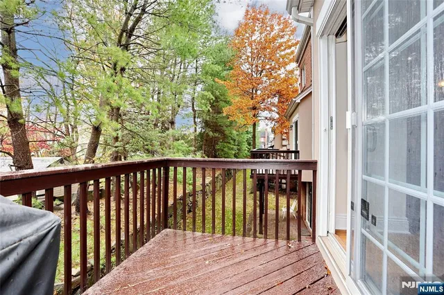 a balcony with wooden floor and fence