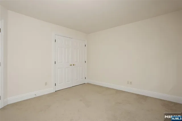 a bathroom with a toilet sink vanity and mirror