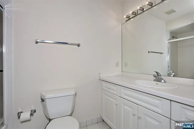 a bathroom with a glass shower door
