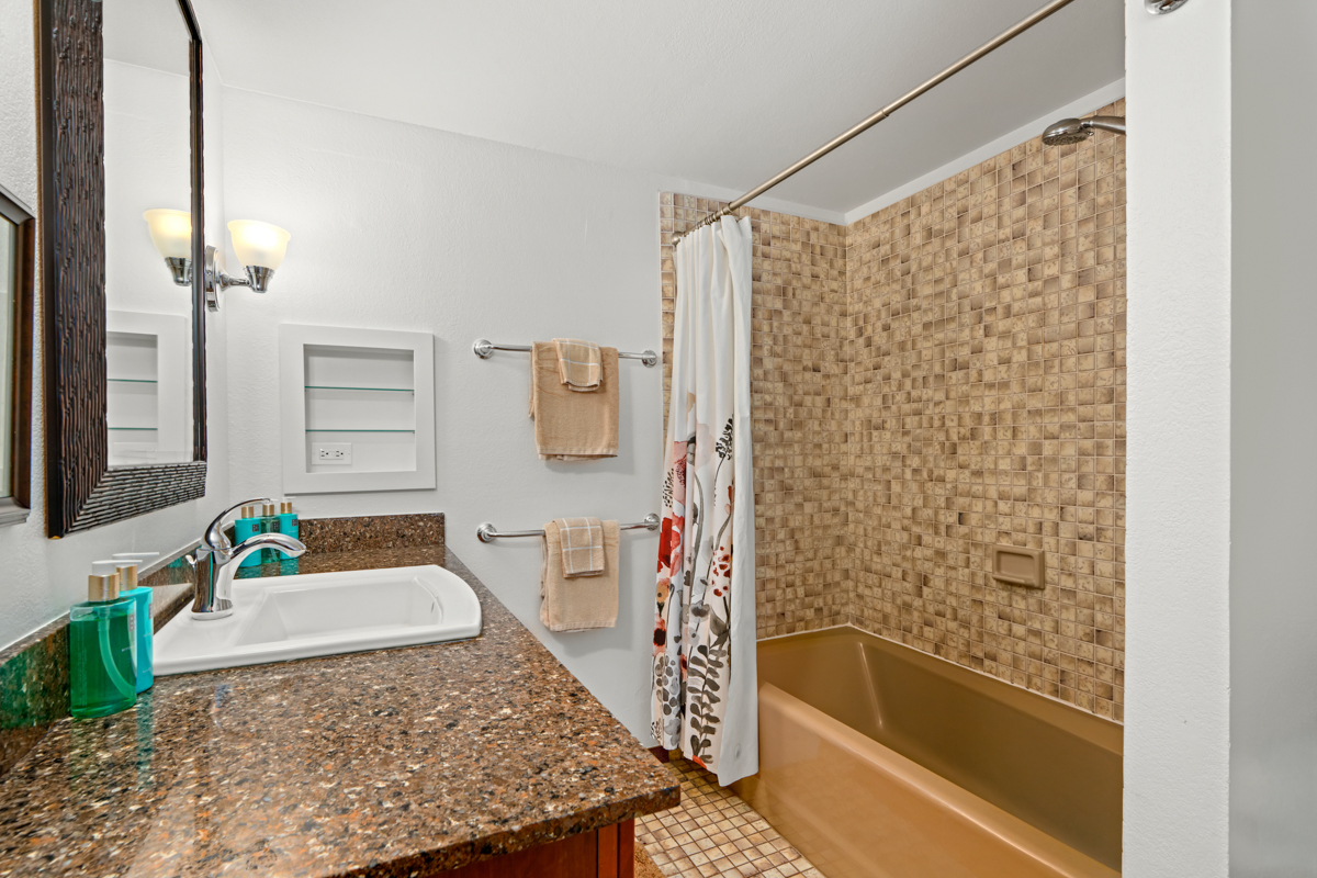 1870 Hoone Road, Unit 602 Koloa, HI 96756 - Photo 15 of 26 a bathroom with a granite countertop sink and a bathtub