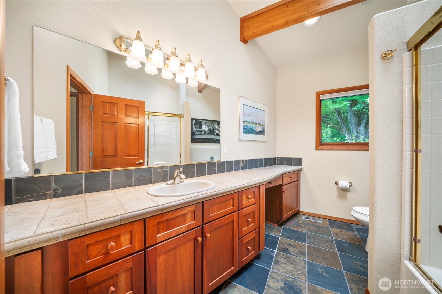 813 Varsity Road Kalama, WA 98625 - Photo 26 of 40 a spacious bathroom with a granite countertop double vanity sink a mirror and a shower