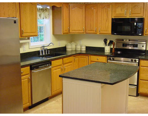 245 Benedict Road Burrillville, RI 02830 - Photo 14 of 25 a kitchen with stainless steel appliances granite countertop a sink a stove and a microwave