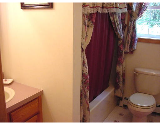 245 Benedict Road Burrillville, RI 02830 - Photo 20 of 25 a bathroom with a toilet and a shower curtain