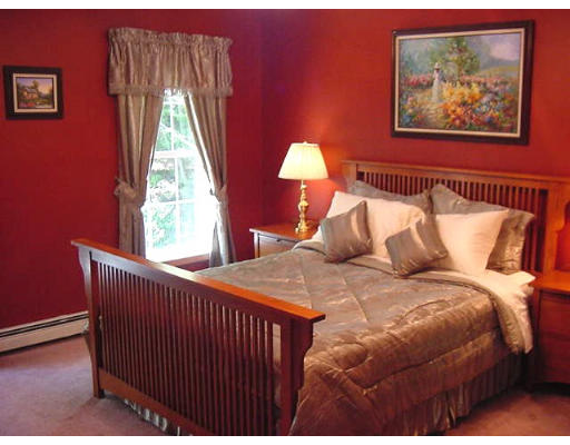 245 Benedict Road Burrillville, RI 02830 - Photo 21 of 25 a bedroom with a bed and a painting on the wall