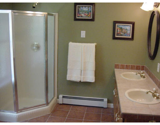 245 Benedict Road Burrillville, RI 02830 - Photo 23 of 25 a bathroom with a sink a mirror and a shower