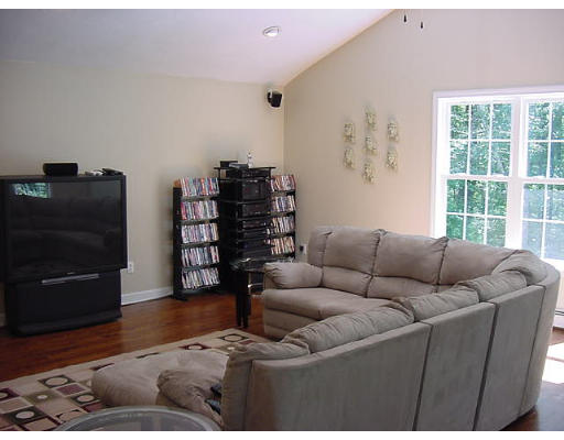 245 Benedict Road Burrillville, RI 02830 - Photo 24 of 25 a living room with furniture and a flat screen tv