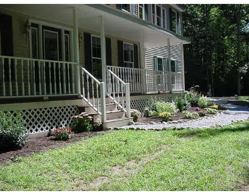 245 Benedict Road Burrillville, RI 02830 - Photo 5 of 25 a view of a chair and table in the back yard
