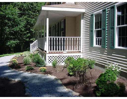 245 Benedict Road Burrillville, RI 02830 - Photo 7 of 25 a view of a house with a small yard and sitting area