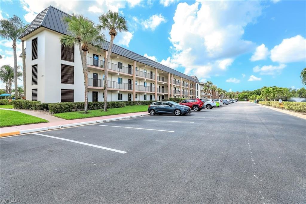 1000 Manatee Road, Unit A306 Naples, FL 34114 - Photo 2 of 13 a cars parked in front of a building