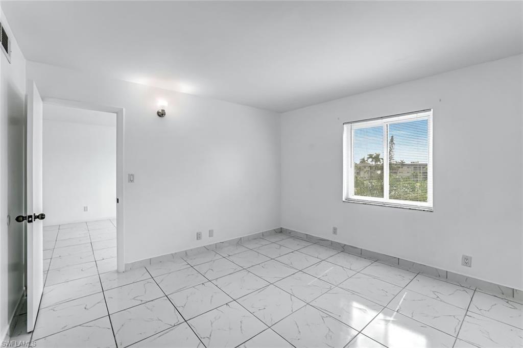 1000 Manatee Road, Unit A306 Naples, FL 34114 - Photo 4 of 13 an empty room with a window