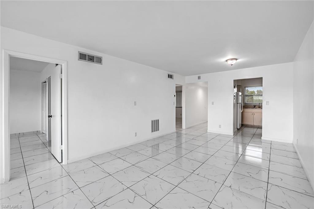 1000 Manatee Road, Unit A306 Naples, FL 34114 - Photo 5 of 13 a view of an empty room and window