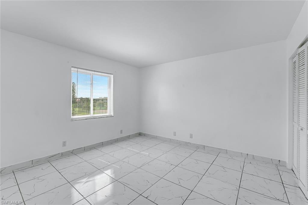1000 Manatee Road, Unit A306 Naples, FL 34114 - Photo 8 of 13 an empty room with windows