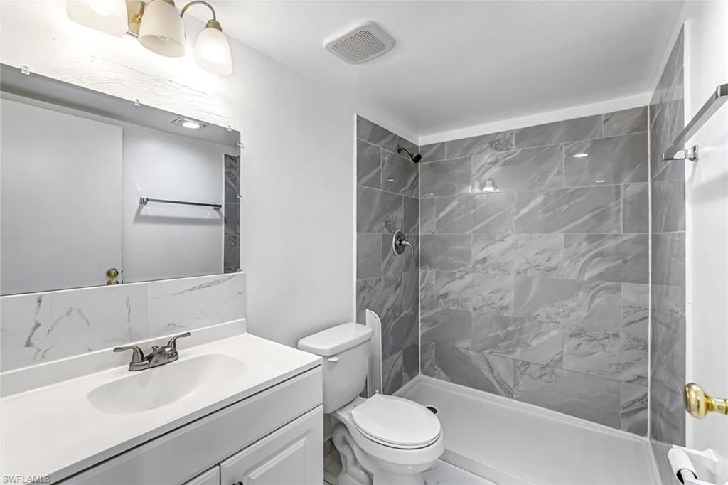 1000 Manatee Road, Unit A306 Naples, FL 34114 - Photo 9 of 13 a bathroom with a sink toilet and shower