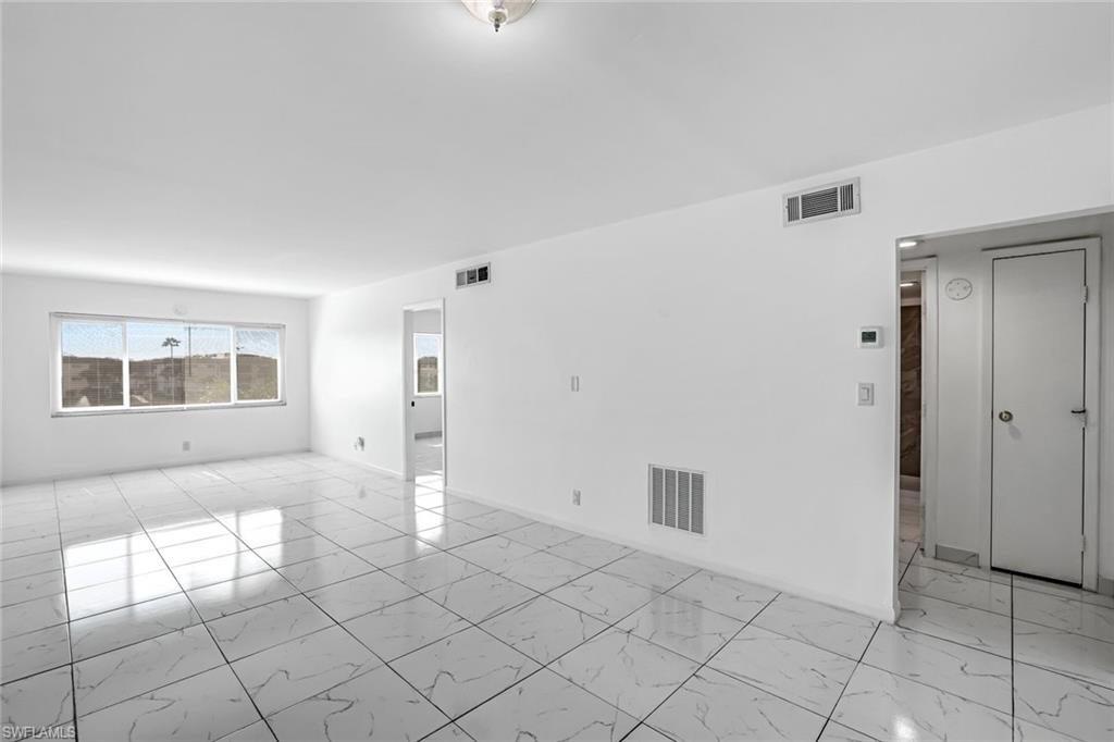 1000 Manatee Road, Unit A306 Naples, FL 34114 - Photo 10 of 13 an empty room with windows and entrance