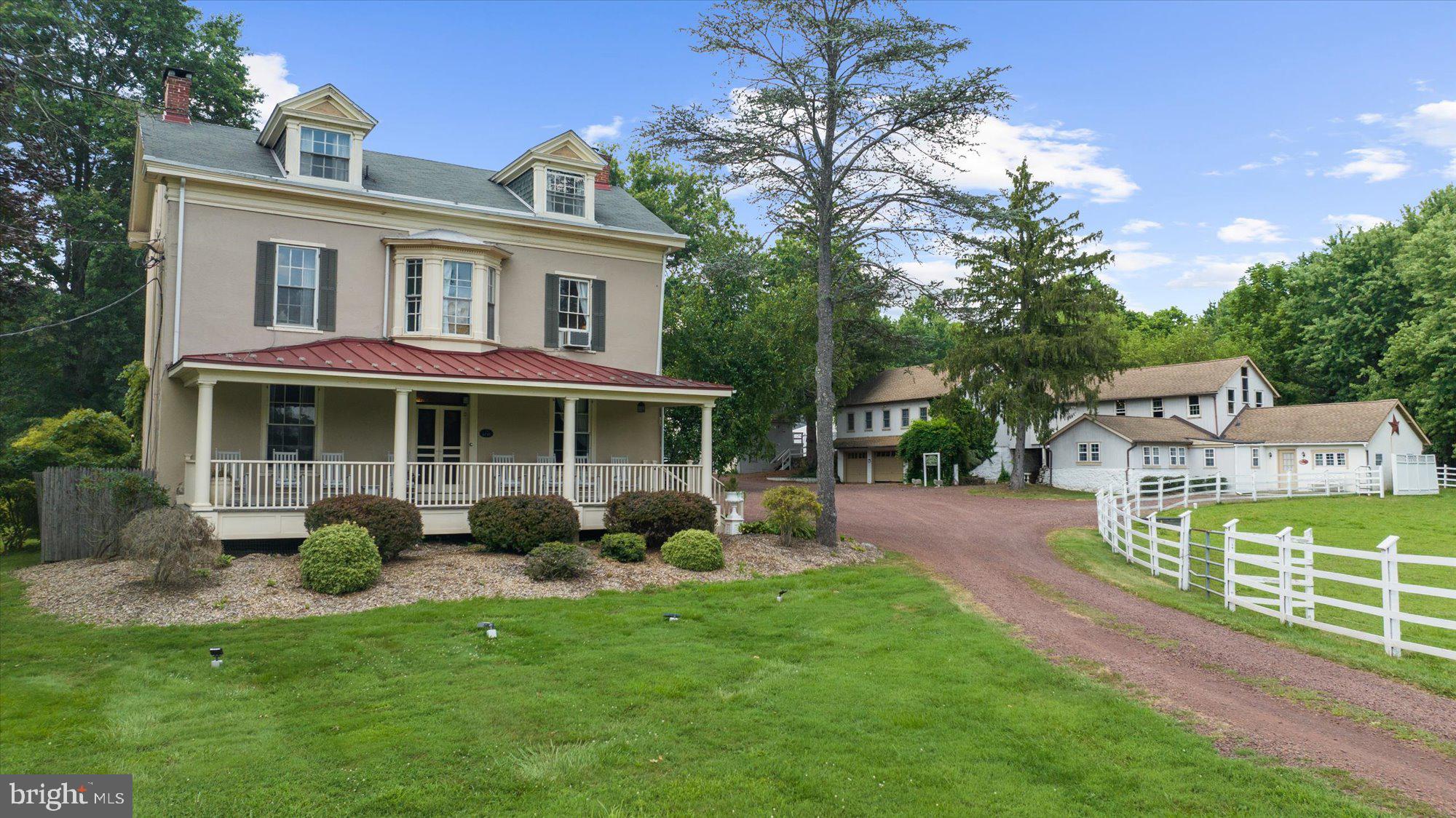 a view of a house with backyard sitting area and garden