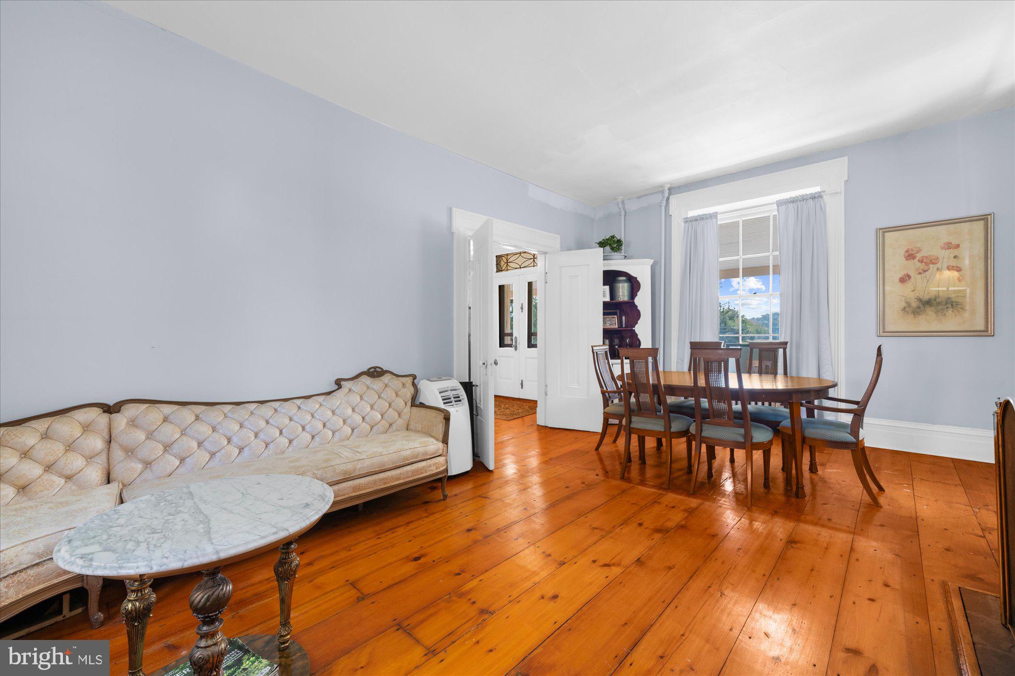 5358 York Road Doylestown, PA 18902 - Photo 15 of 61 a living room with furniture and a dining table with wooden floor
