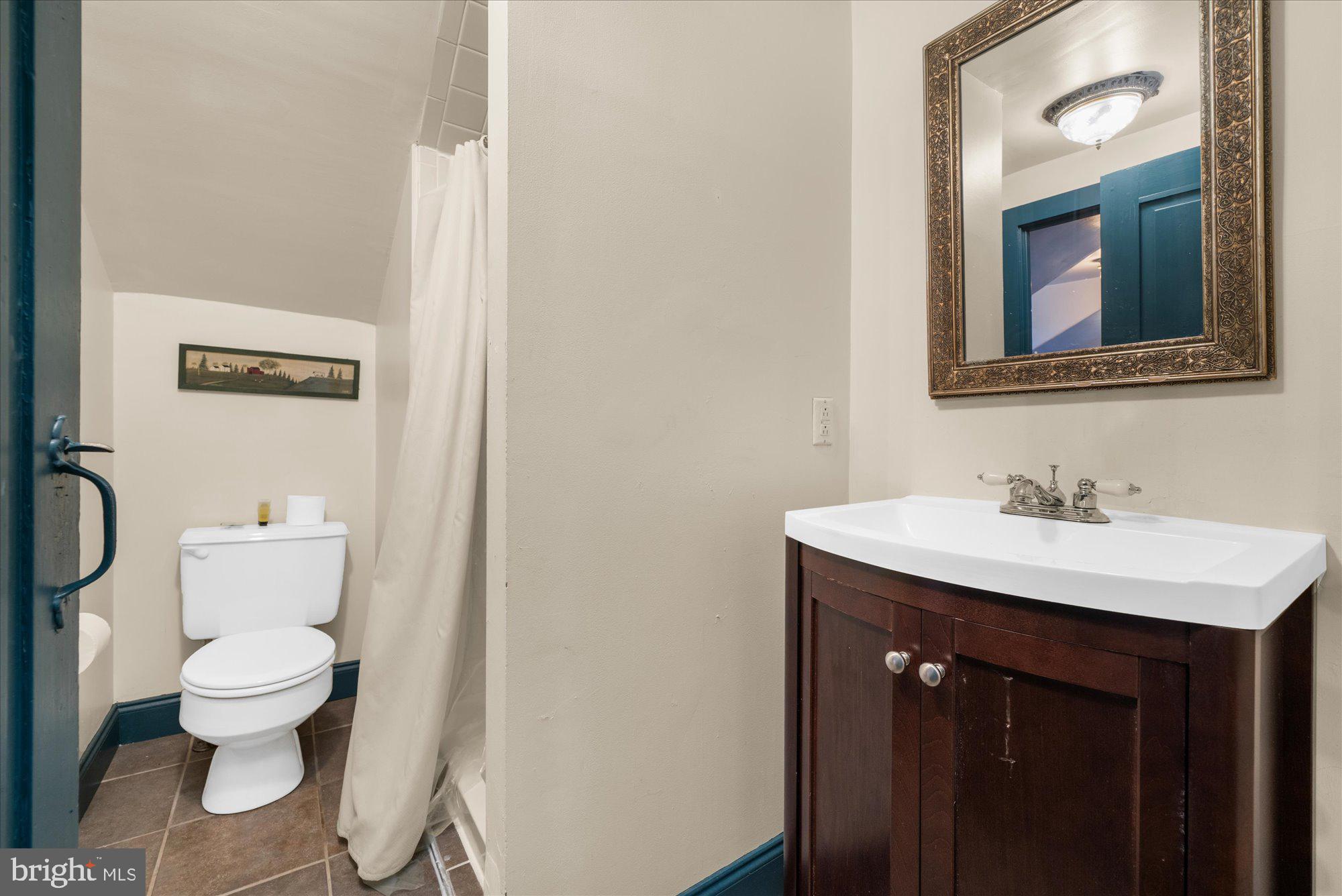 5358 York Road Doylestown, PA 18902 - Photo 28 of 61 a bathroom with a toilet sink and mirror