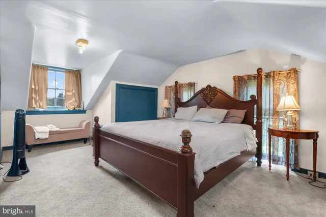 a spacious bathroom with a toilet a sink and a mirror