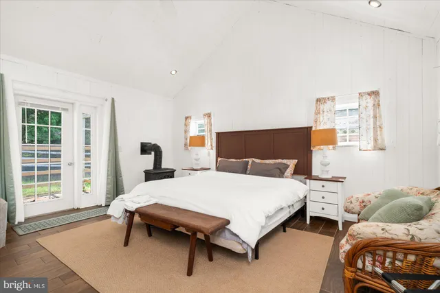 a spacious bedroom with a bed and large windows