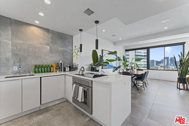 a kitchen with a sink and chairs